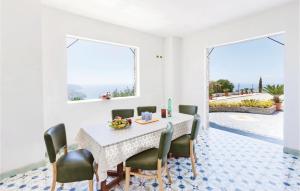 a dining room with a table and chairs with a view at 3 Bedroom Lovely Home In Agropoli Sa in Ogliastro Cilento