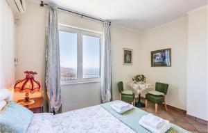 a bedroom with a bed and a large window at 3 Bedroom Lovely Home In Agropoli Sa in Ogliastro Cilento