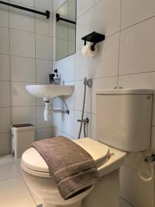 a bathroom with a toilet and a sink at Imperio Professional Suite by 188AOR in Alor Setar