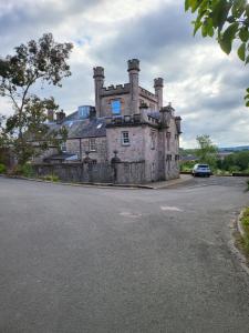an old house on the side of a road at Langhouse Castle Bed and Breakfast in Inverkip