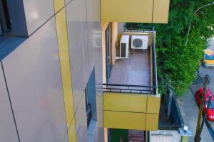 an overhead view of a yellow building with a balcony at Residence Le Carat Silverline in Douala