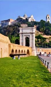 a building with an arch in the middle of a grass field at Il Balcone Sul Corso in Ancona