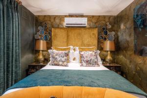 a bedroom with a large bed and two lamps at Funky Monk Hotel in Epping