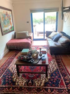 a living room with a couch and a coffee table at Villa Paulina Family suite in Langebaan