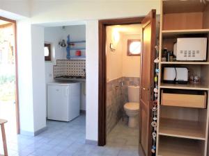 a bathroom with a toilet and a sink at Villette Corallo in Malfa