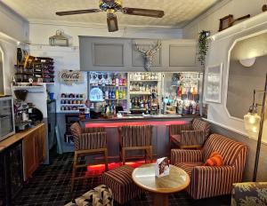 a bar with two chairs and a table in a room at Newholme Hotel in Blackpool