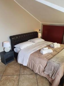 a bedroom with a large bed with towels on it at Attic A31 apartament rooftop deluxe in Santa Maria Capua Vetere +68 photos