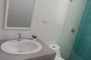 a bathroom with a sink and a toilet at Chicama D'Amore Dpto Familiar Kids & Wave on PtoMalabrigo in Puerto Chicama +8 photos