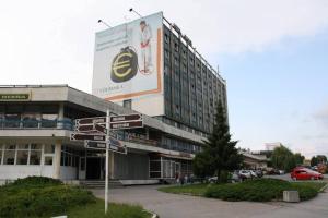 a large building with a sign on the side of it at Apartmány Šariš in Prešov