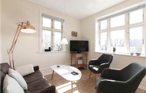 a living room with a couch and two chairs and a tv at Beautiful Home In Gudhjem With 2 Bedrooms And Wifi in Gudhjem