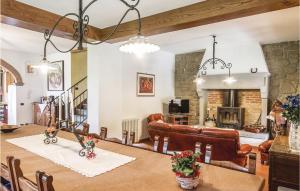 a dining room with a table and a fireplace at La Quiete in Moggiona