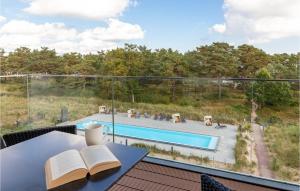 an open book on a table with a view of a pool at Pearl in Binz
