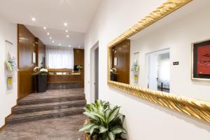 a hallway with a large mirror on the wall at Hotel Pittini in Gemona del Friuli