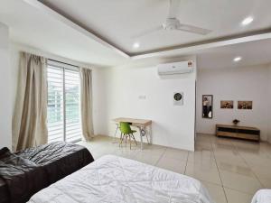 a bedroom with a bed and a desk in it at Botani Tmn Cyber Ipoh(24 pax /tv box/mahjong) in Ipoh