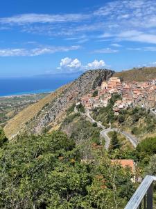 a village on a hill with the ocean in the background at Villa vista mare in Maierà