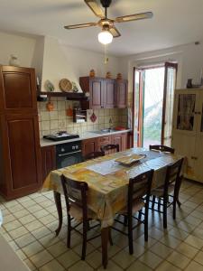 cocina con mesa, sillas, mesa y techo en Villa vista mare, en Maierà