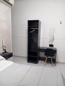 a bedroom with a black desk and a chair at Hotel stranamore in Varcaturo