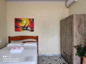 a bedroom with two beds and a cabinet at Pousada Meu Xodó in Prea