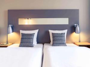 Postel nebo postele na pokoji v ubytování Mercure Hotel Düsseldorf City Nord