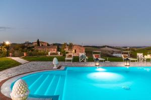 a swimming pool in front of a house at VILLA LAJATICO Farmhouse with Private Pool in Peccioli