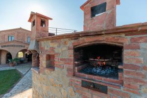a brick oven with a fire inside of it at VILLA LAJATICO Farmhouse with Private Pool in Peccioli