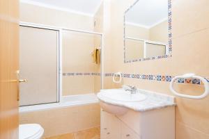 a bathroom with a sink and a shower and a toilet at Recanto da Galé by Umbral in Albufeira +8 photos