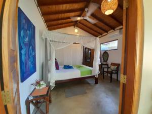 a bedroom with a bed with a canopy at Angelica Villa in Bentota