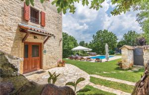 an external view of a stone house with a swimming pool at Pet Friendly Home In Basici With Outdoor Swimming Pool in Bašići