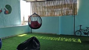 a room with a hammock hanging from a window at Sant Kripa Backpackers Hostel in Jodhpur
