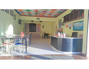 a restaurant with tables and chairs in a room at Hotel Rudra and Restaurant, Gopeshwar in Gopeshwar