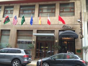 a building with flags on the front of it at Hôtel Les Saisons in Casablanca