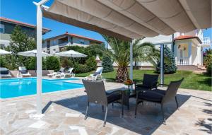 a patio with a table and chairs and a pool at Beautiful Home In Pula in Pula +34 photos