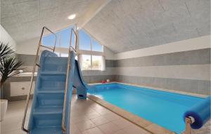 a swimming pool with an slide in a room at Gorgeous Home In Vejby With Indoor Swimming Pool in Vejby