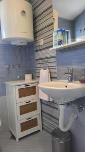 a bathroom with a sink and a white sink at Apartmani Goga in Skradin