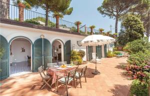 a patio with a table and chairs and an umbrella at Casa Sorvillo in Vietri sul Mare