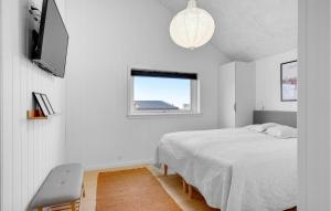 a white bedroom with a bed and a window at 4 Bedroom Stunning Home In Sjlund in Sjølund