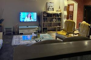 sala de estar con sofá y TV en Delta en Yeda