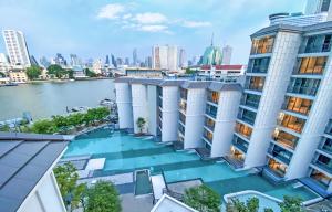 an aerial view of a building with a river at The Quarter Chaophraya by UHG in Bangkok