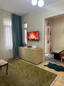 a living room with a tv on top of a dresser at Nelly Guesthouse in Istanbul