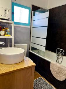 a bathroom with a tub and a sink and a shower at Authentique T3 calme entre mer et Calanques in Marseille