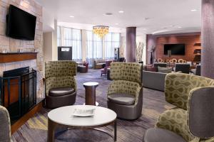 a waiting room with chairs and a fireplace at Courtyard Bethlehem Lehigh Valley/I-78 in Bethlehem