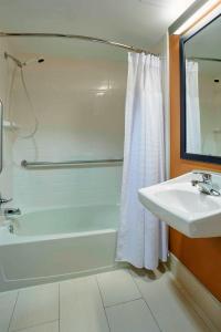 a bathroom with a white tub and a sink at Fairfield Inn by Marriott Kalamazoo West in Kalamazoo