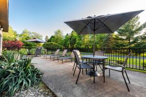 a patio with a table and chairs and an umbrella at Fairfield Inn Battle Creek in Battle Creek