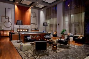 a living room with a couch and a fireplace at Renaissance Atlanta Midtown Hotel in Atlanta