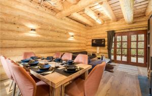 a wooden dining room with a table and chairs at Cozy Home In Brod Na Kupi With Kitchen in Brod na Kupi