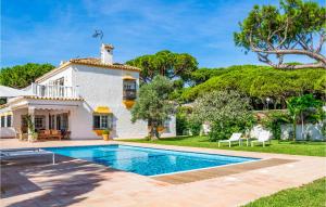 a villa with a swimming pool in front of a house at Awesome Home In Marbella With Wifi in Marbella