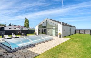 a swimming pool in the backyard of a house at Amazing Home In Strby With House Sea View in Strøby