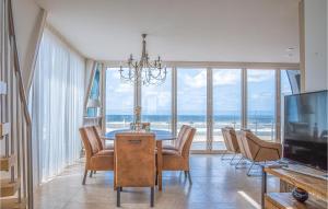a dining room with a table and chairs and the ocean at Appartement Shrimp in Egmond aan Zee
