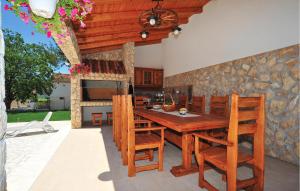 a kitchen with a wooden table and chairs at Lovely Home In Sibenik With Wifi in Šibenik