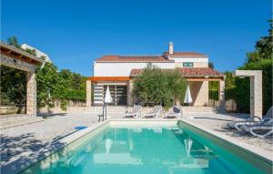 a villa with a swimming pool and a house at Lovely Home In Sibenik With Wifi in Šibenik